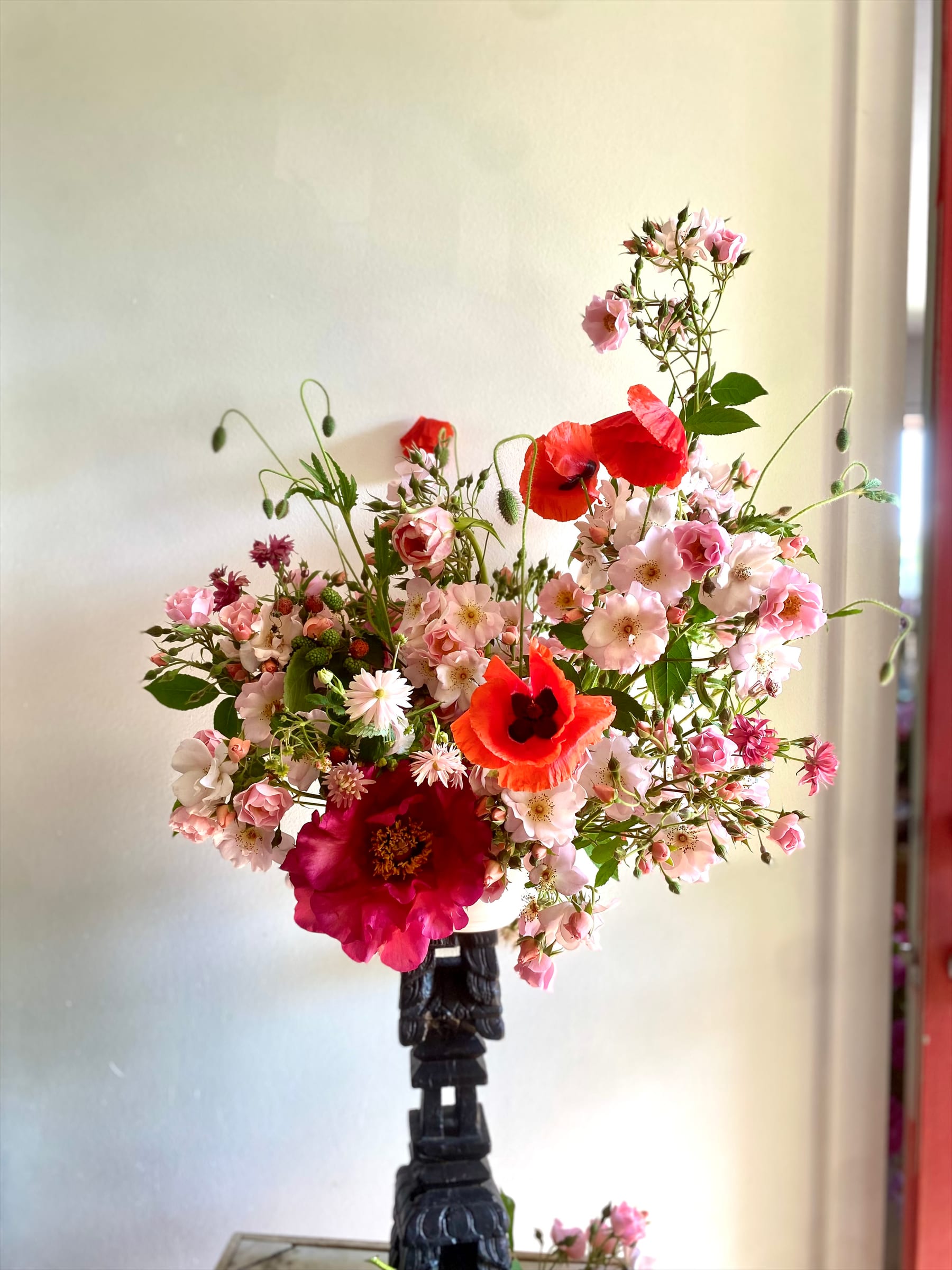 Red and white arrangement in studio window